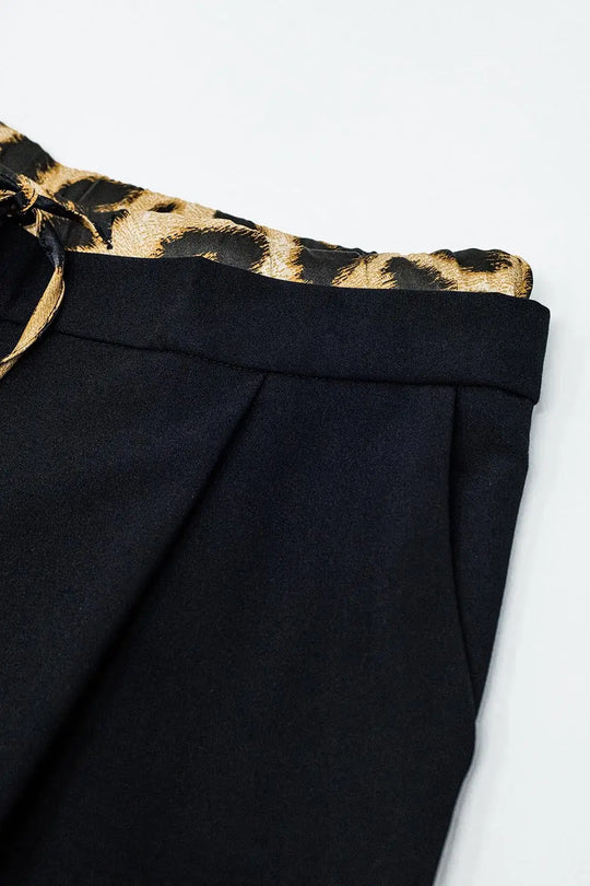Long black pleated pants with leopard detail at the waist - Pants