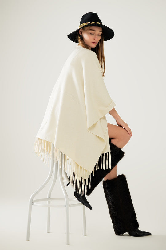 Soft knitted poncho in beige with fringes