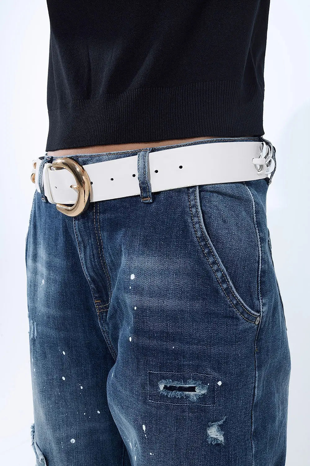 Loose-fitting jeans with distressed patches and paint details