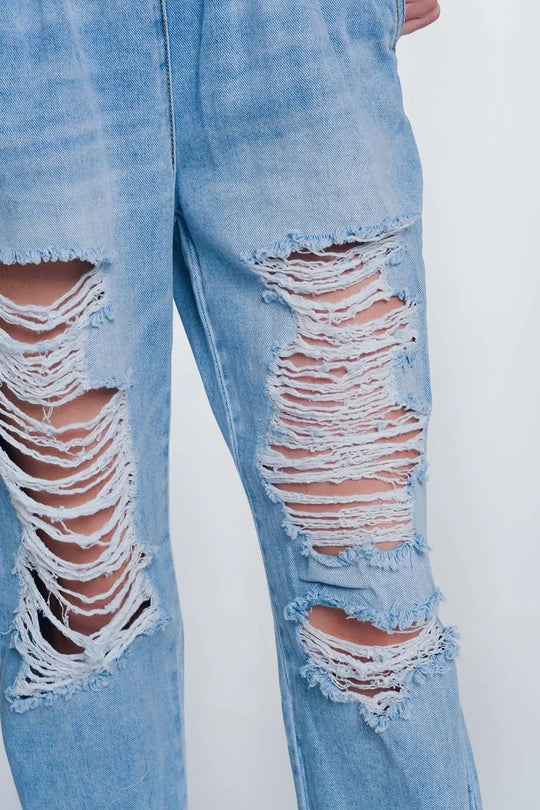 Heavily ripped boyfriend jeans in light denim