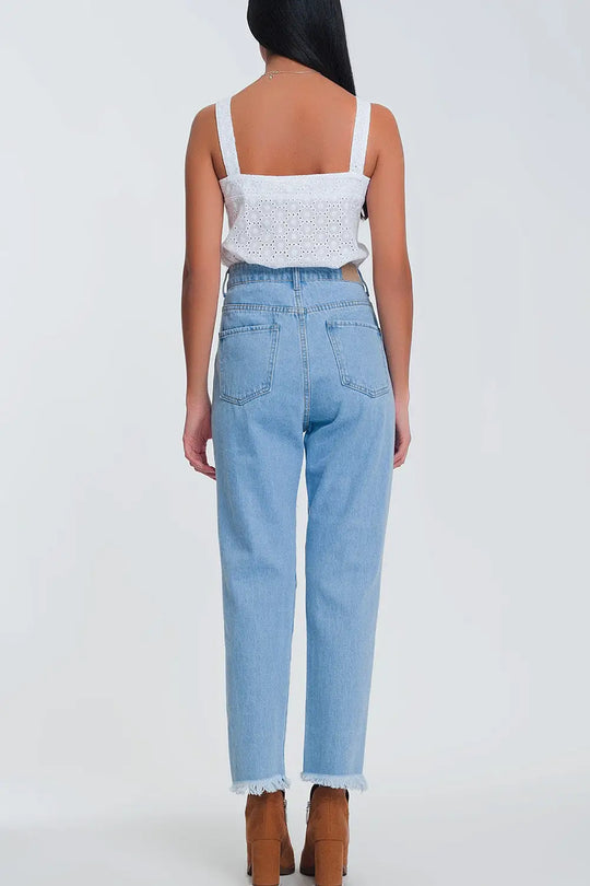 High waist mom jeans with busted knees in light denim