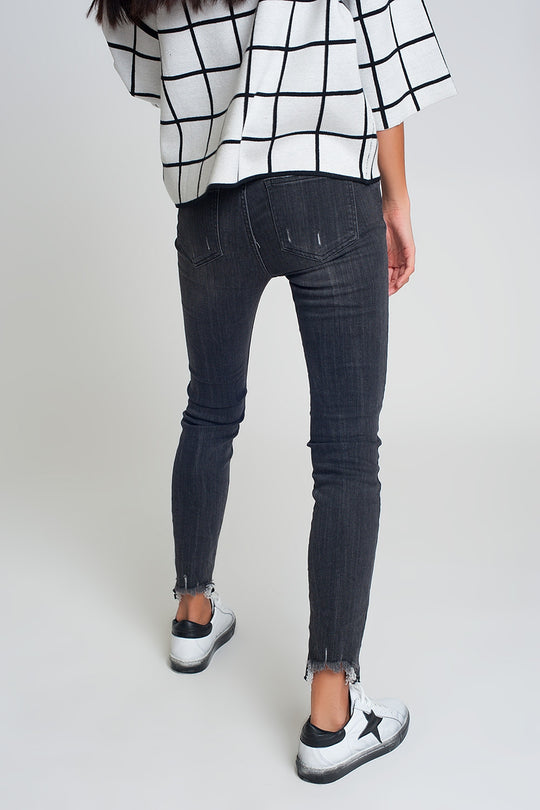 mid rise jeans in black with raw hem