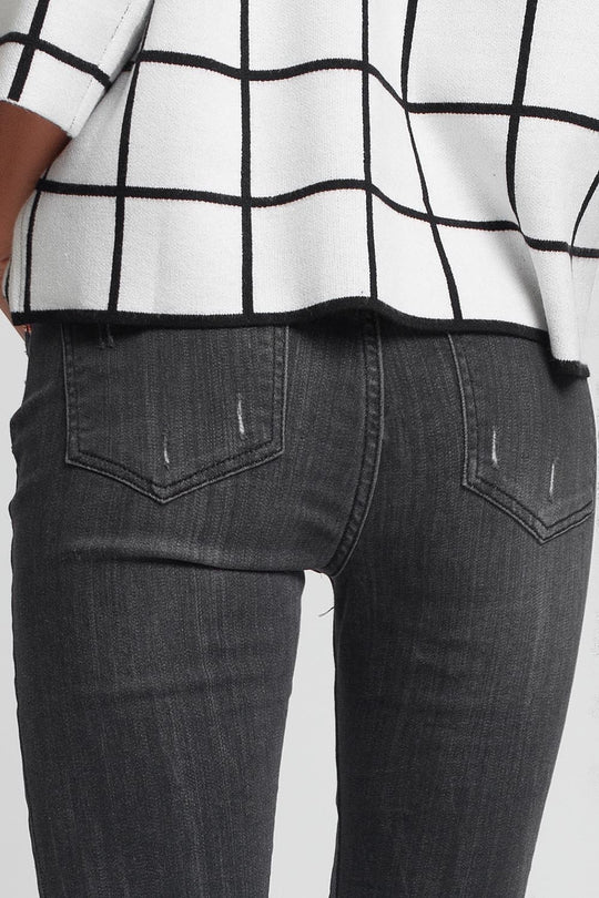 mid rise jeans in black with raw hem