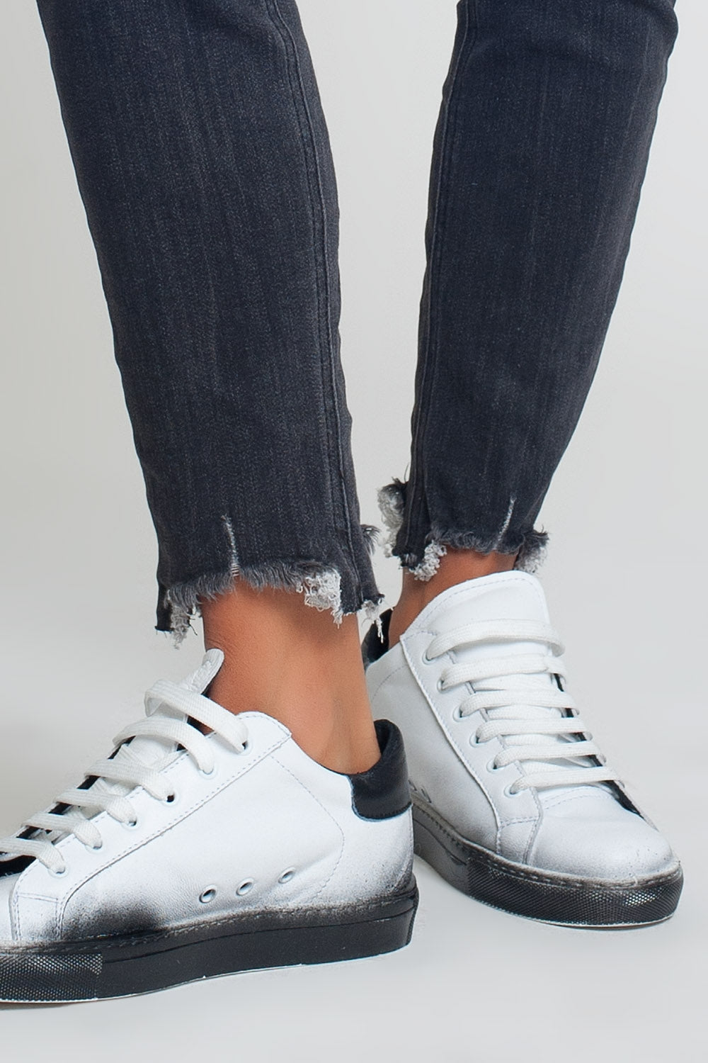 mid rise jeans in black with raw hem
