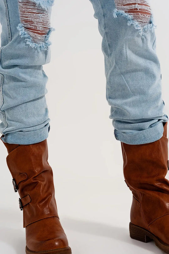 Straight leg distressed jeans with button detail in light blue