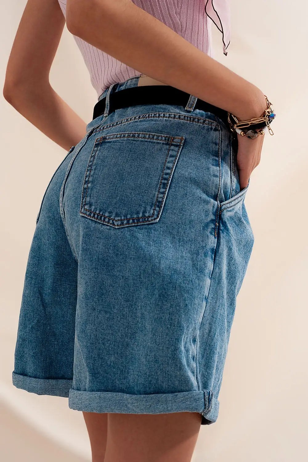 High waisted pleated denim shorts in mid wash