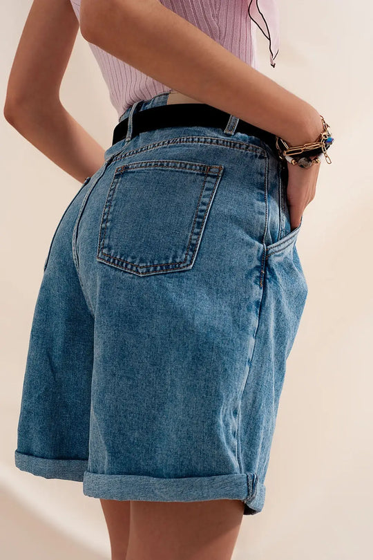 High waisted pleated denim shorts in mid wash