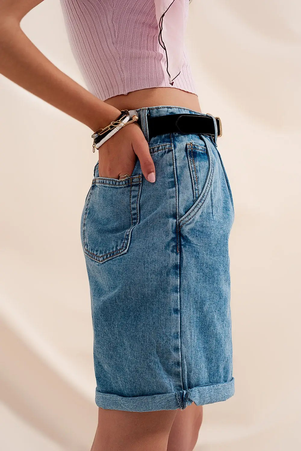 High waisted pleated denim shorts in mid wash
