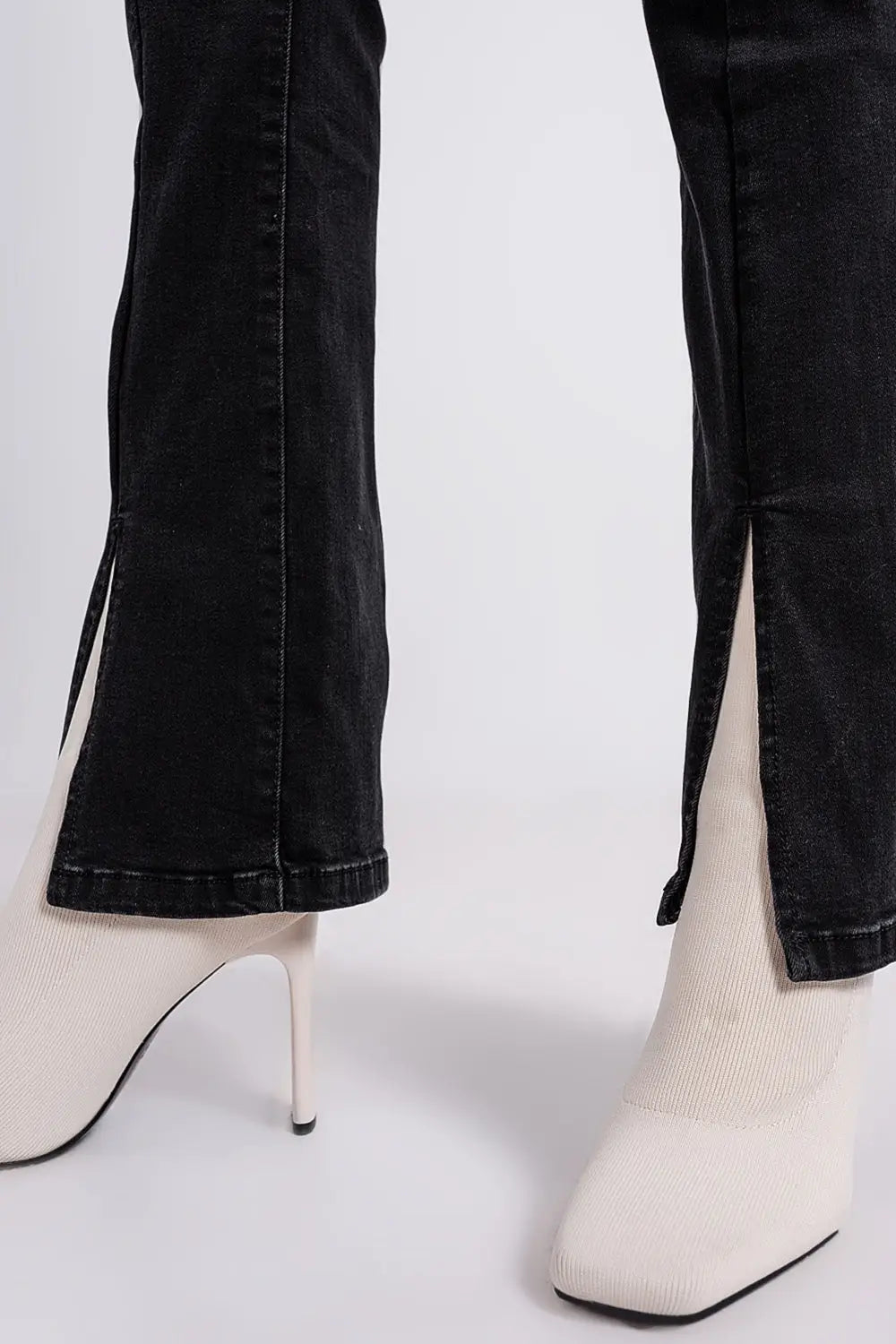 Flare black jeans with split hem