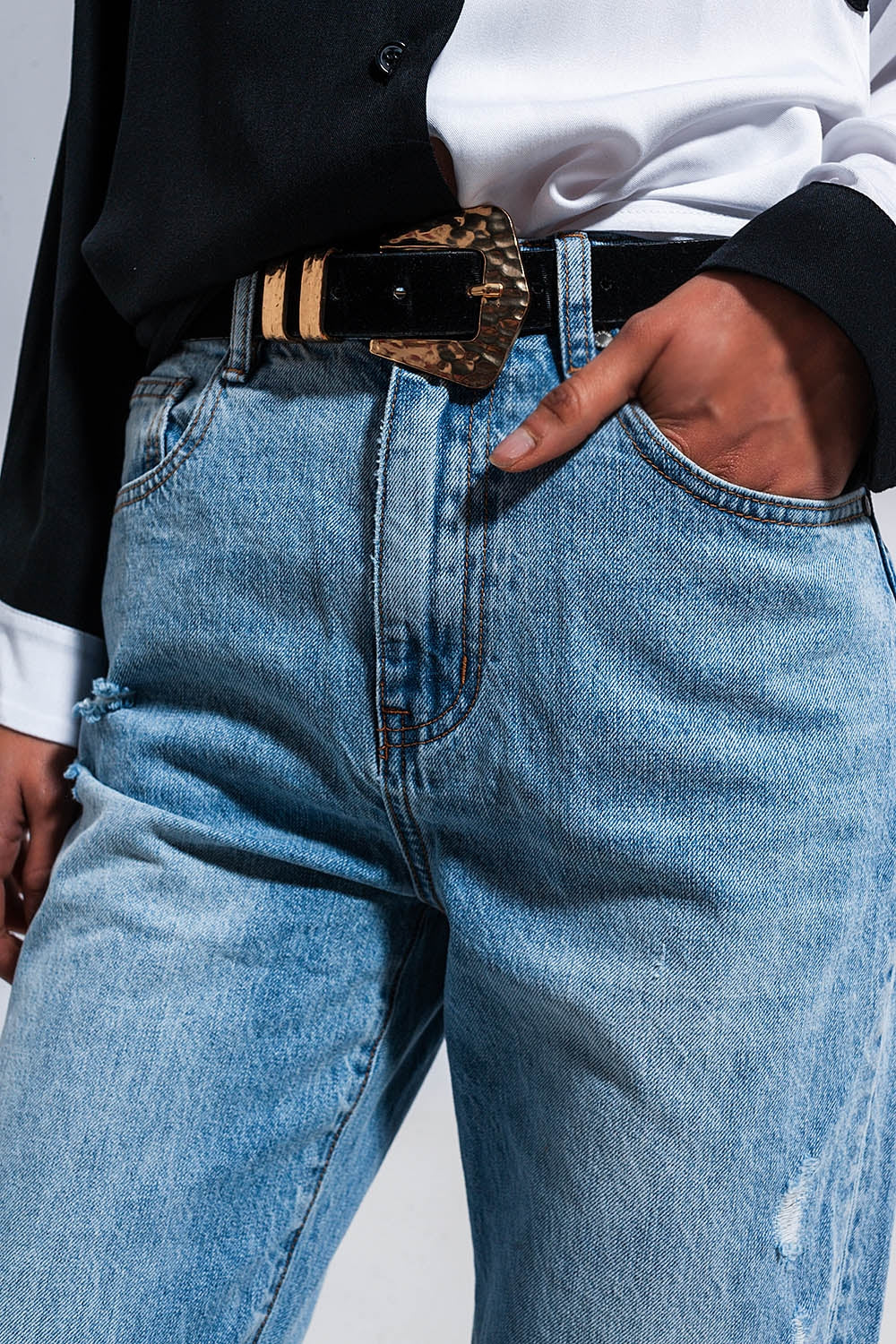 Distressed straight leg jean in medium denim