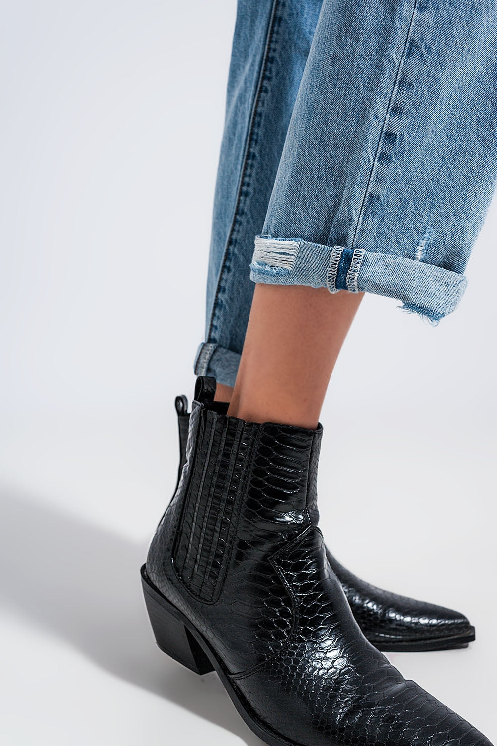 Distressed straight leg jean in medium denim