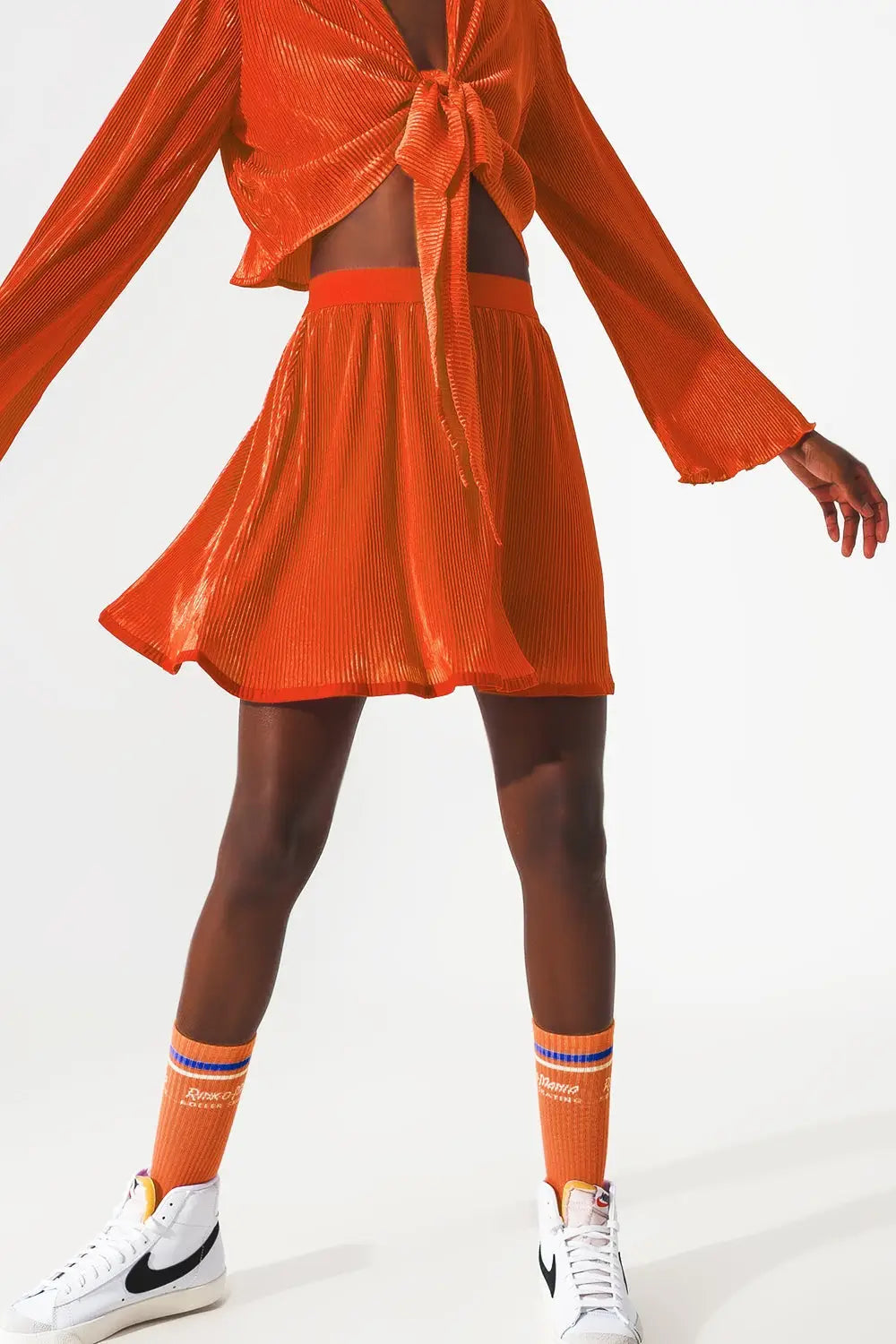 Pleated short skirt in orange - Skirts