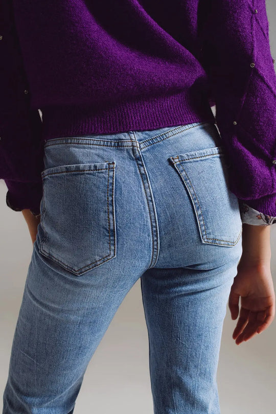 Straight leg jeans with distressed hem in light blue