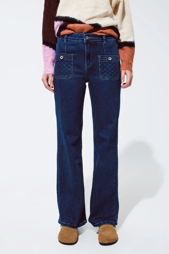 Blue jeans with buttoned pocket details in dark wash
