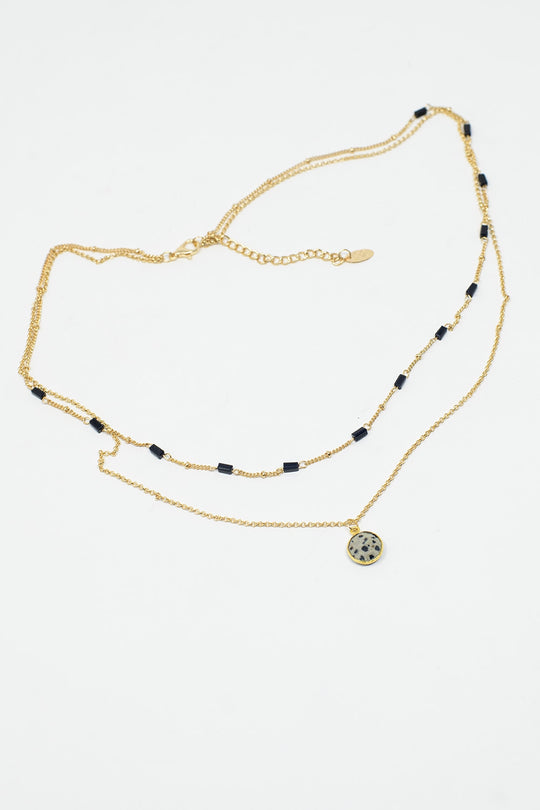 Short 2 in 1 Gold Necklace with Black Beads and White Marbled Stone.
