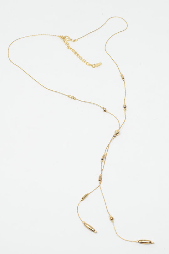 Long Gold Necklance with golden beads throughout and Long golden Tassle