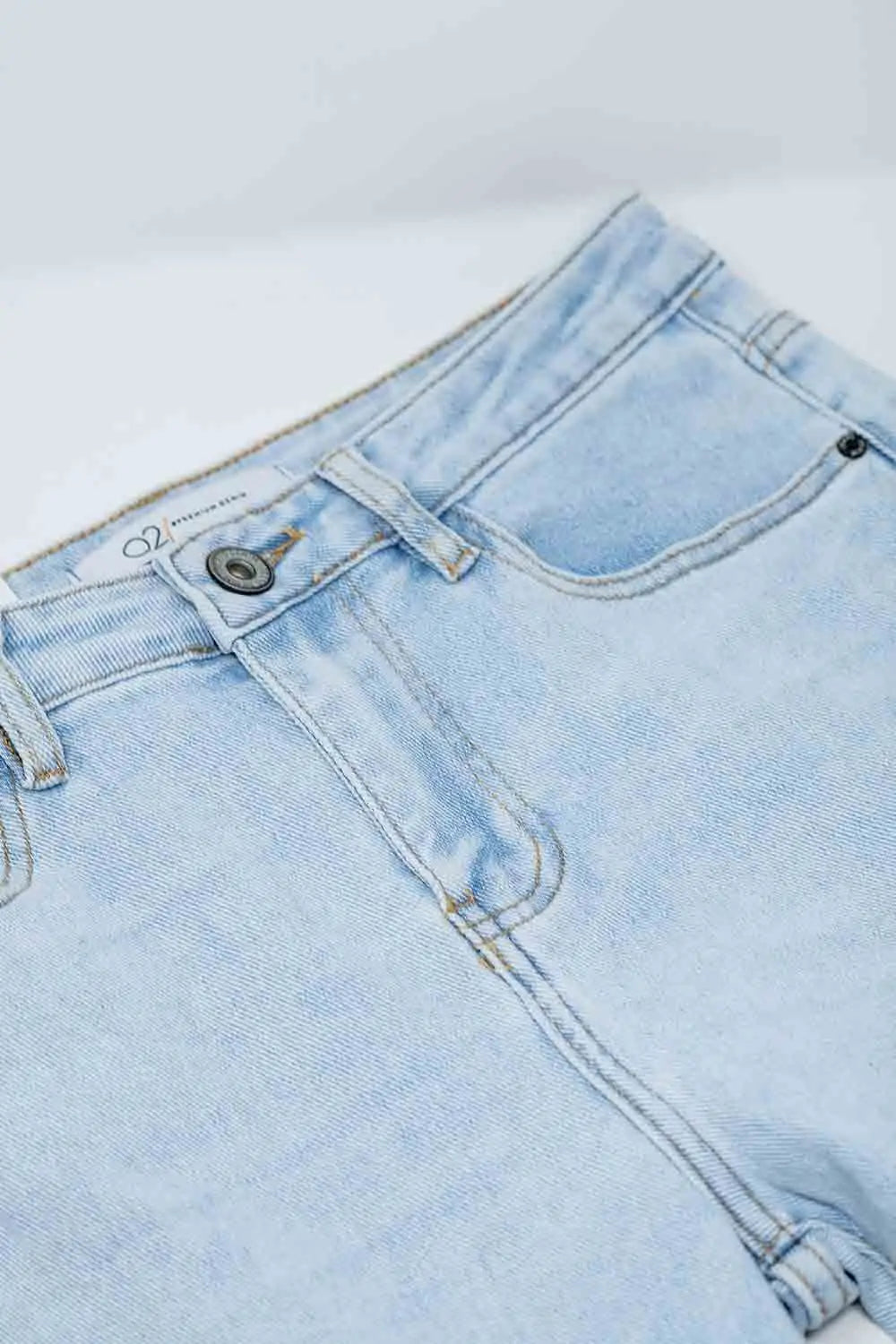 Flared light blue jeans with five pockets and seamless finish