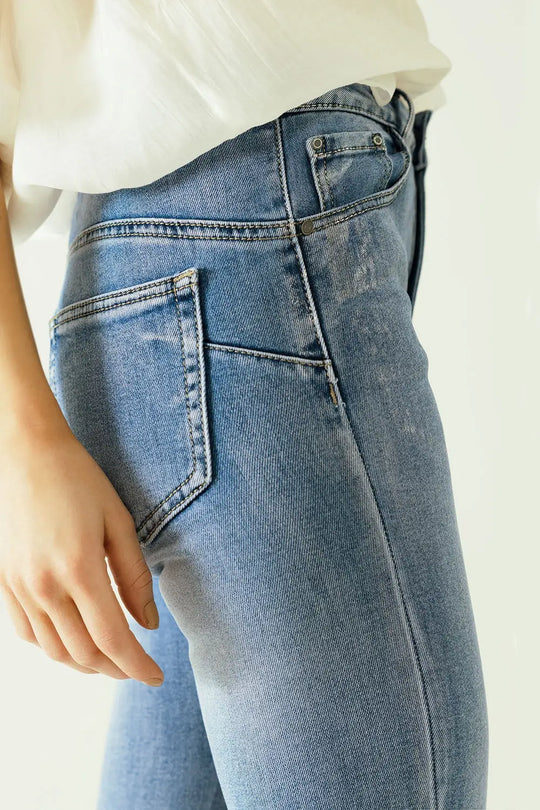 High-waisted jeans with five pockets with silver powder-coated effect