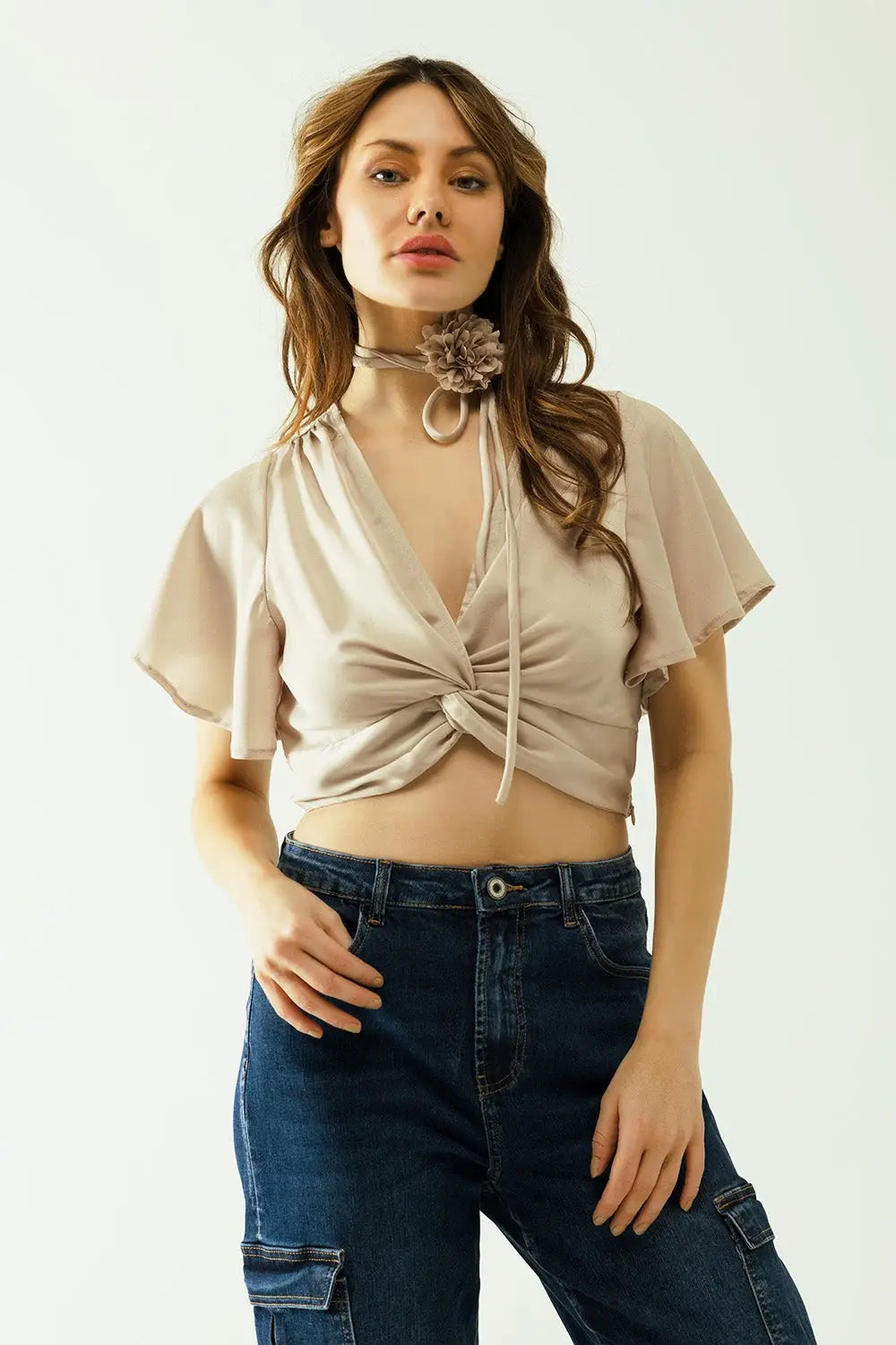 Beige V-neck crop top with short sleeves and a flower detail on the neck - Tops