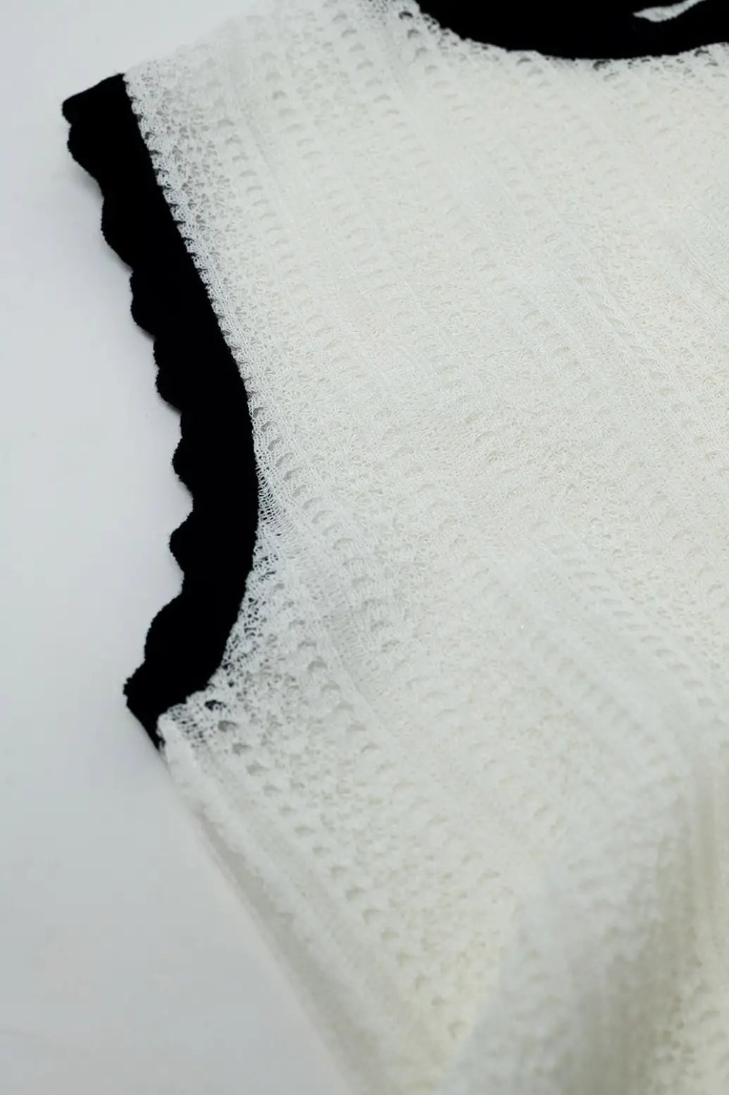 white knitted pointelle top with black wavy trim - Sweaters