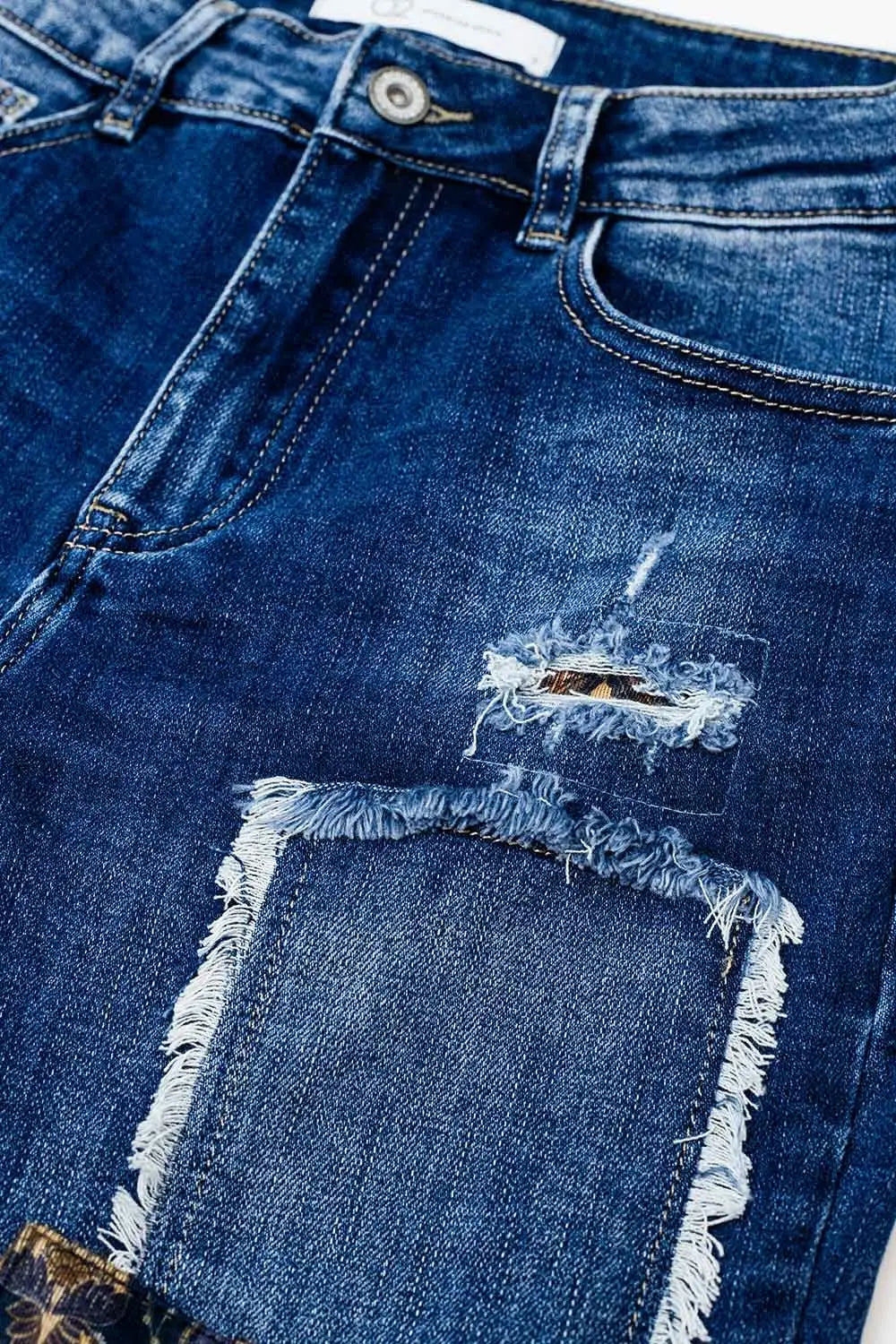 Loose blue jeans with subtle ripped design and patches