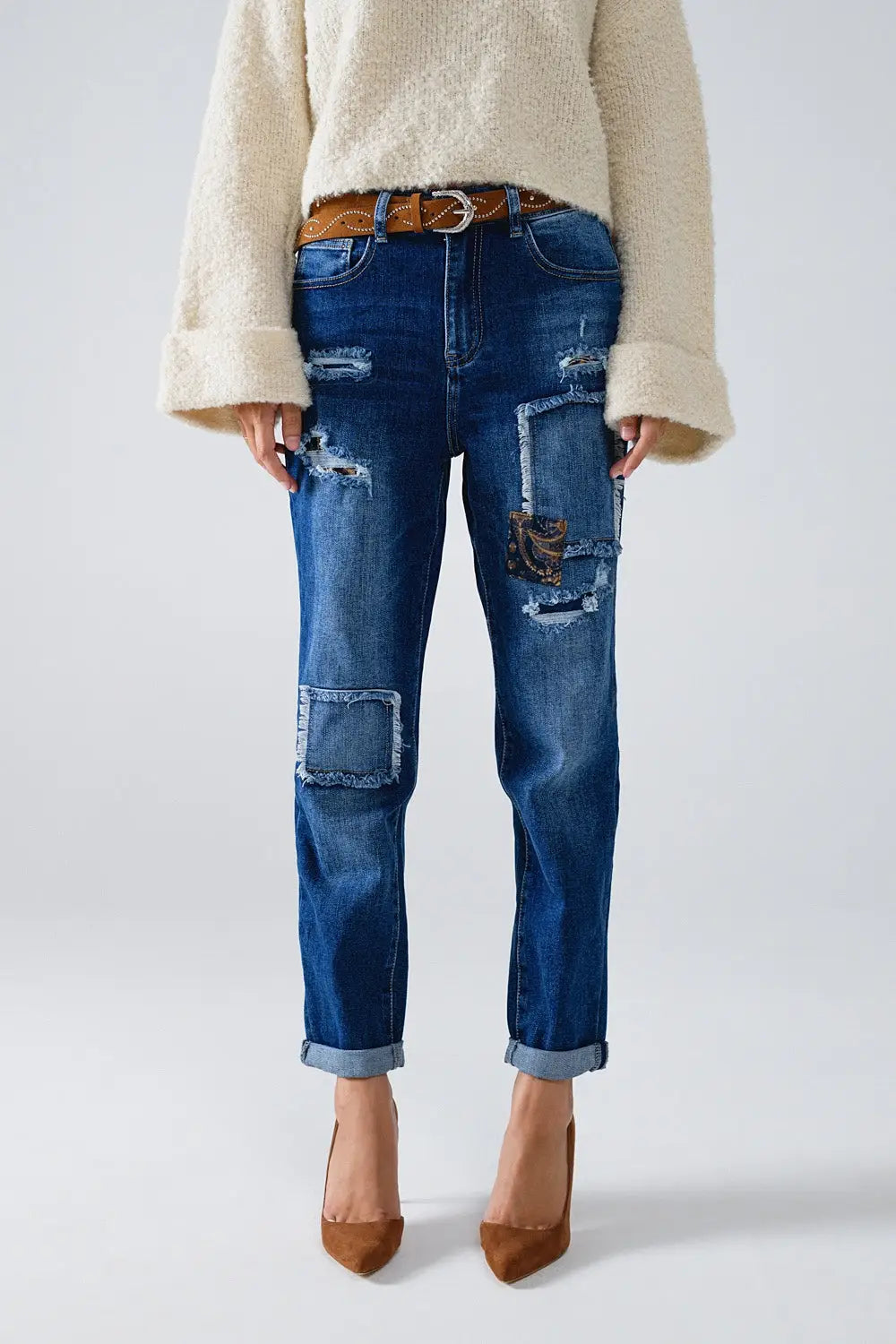 Loose blue jeans with subtle ripped design and patches