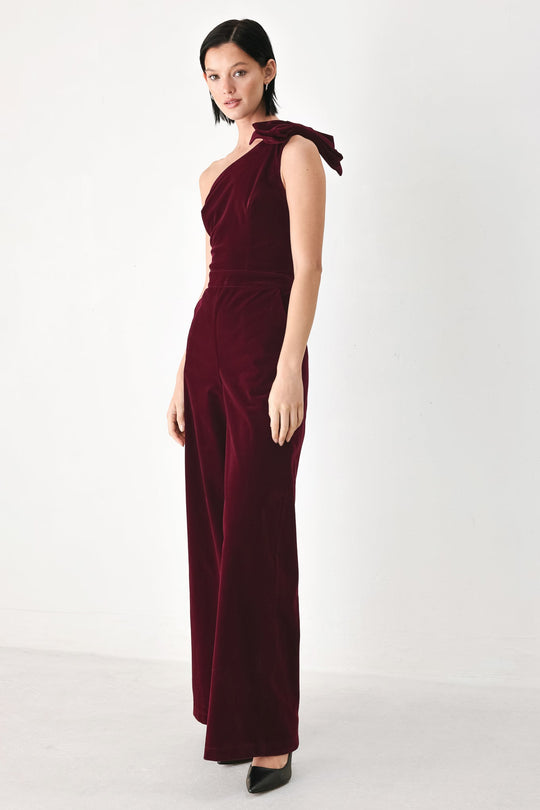 BERRY AFTER DARK VELVET BOW ONE-SHOULDER JUMPSUIT