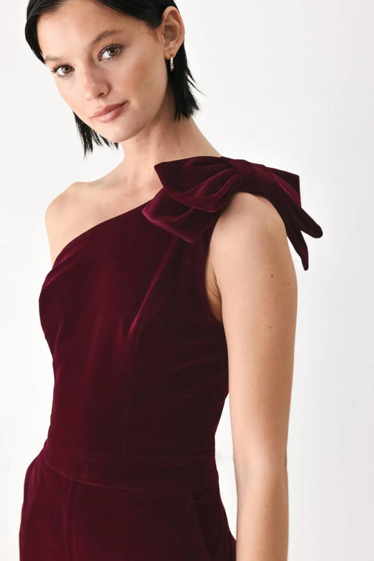 BERRY AFTER DARK VELVET BOW ONE-SHOULDER JUMPSUIT