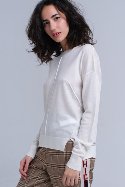 Asymmetric sweater in cream