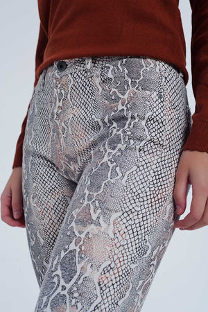 Q2 beige coloured pants with snake print