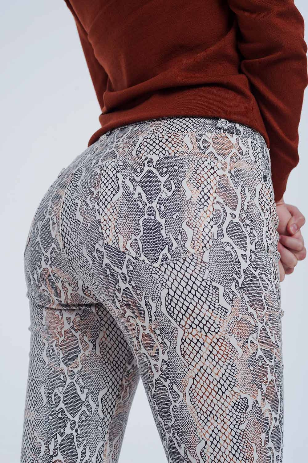 beige coloured pants with snake print