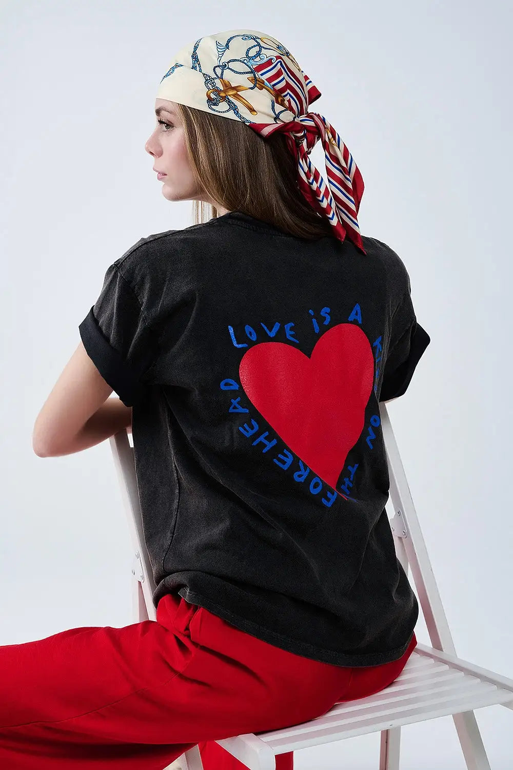 Q2 Black T-shirt featuring a heart design on both the front and back