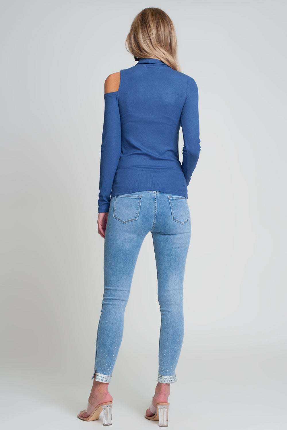 Blue sweater with one open shoulder and high neck