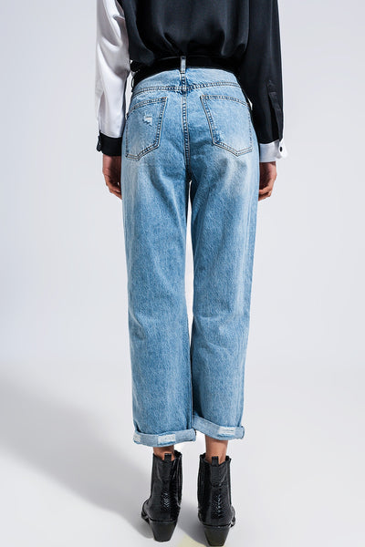 Distressed straight leg jean in medium denim