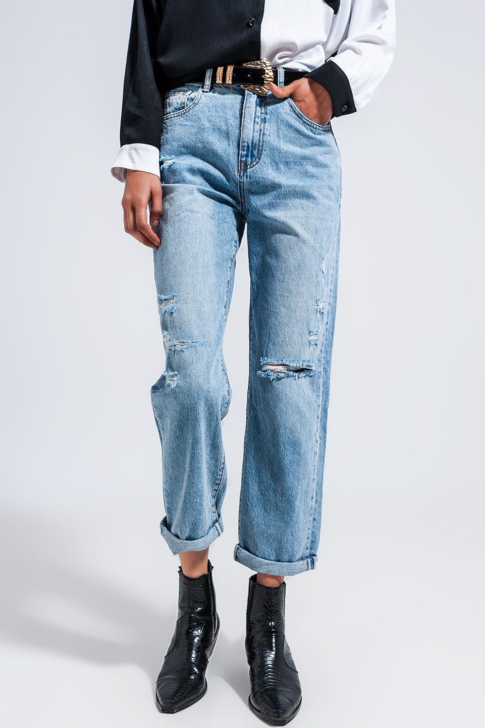 Distressed straight leg jean in medium denim