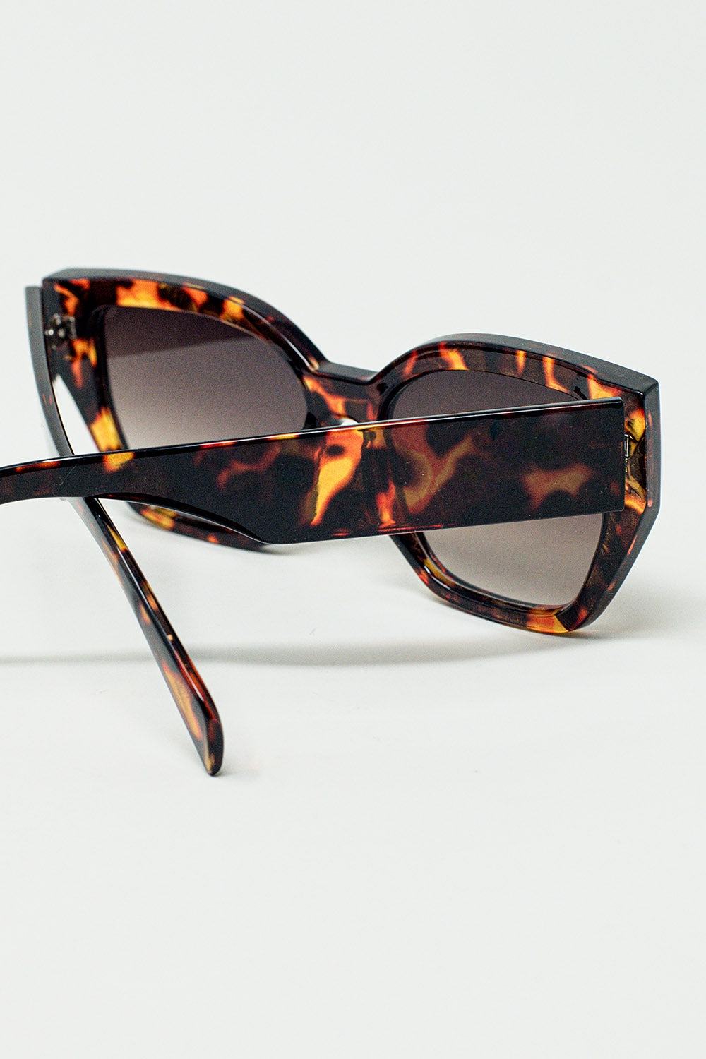 geometric polarized sunglasses with gradient dark lenses and tortoise shell