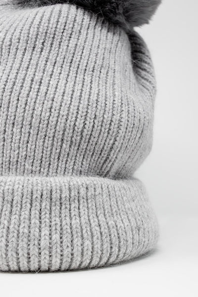 Gray knitted hat with pompom