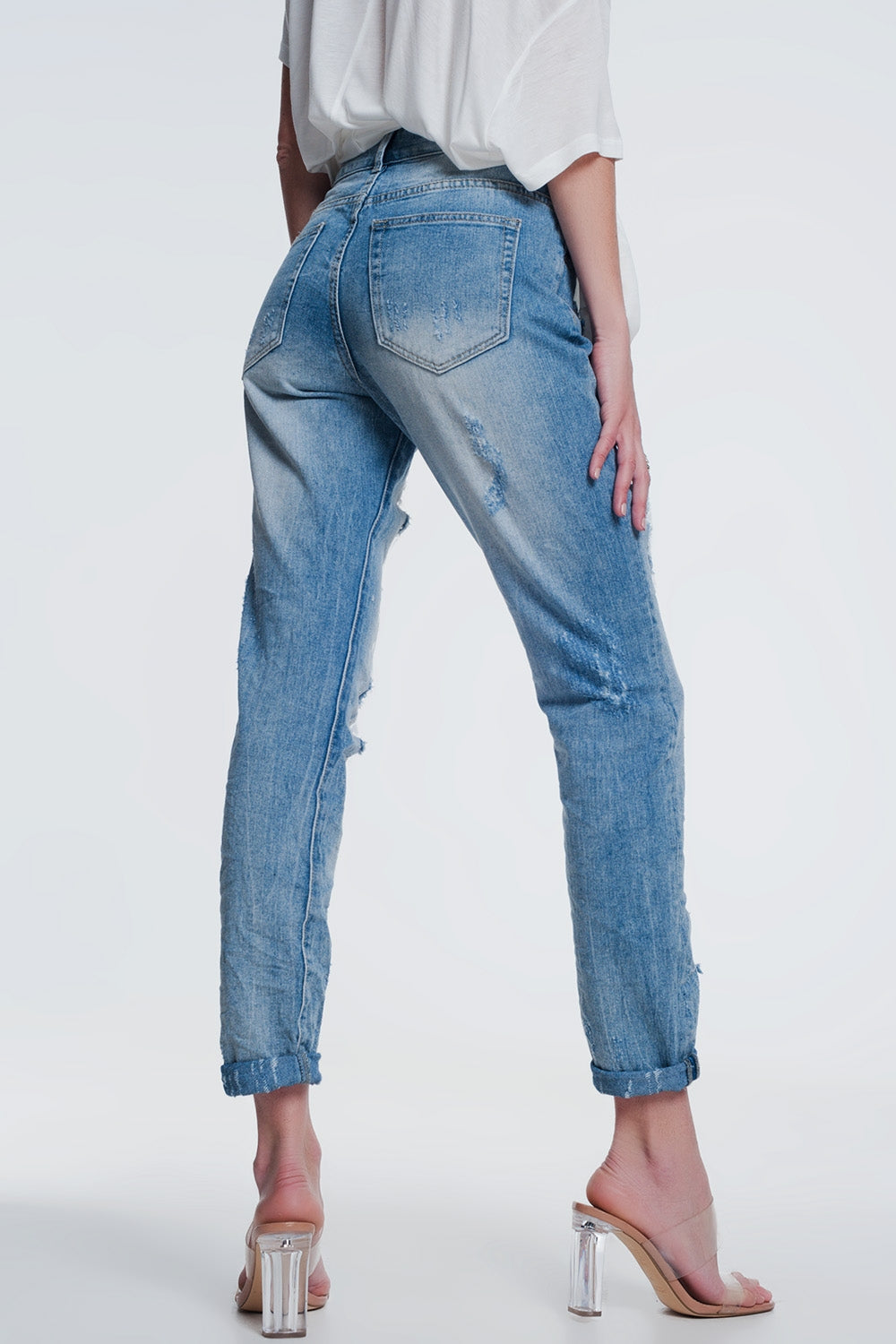 Heavily torn straight jeans in light denim