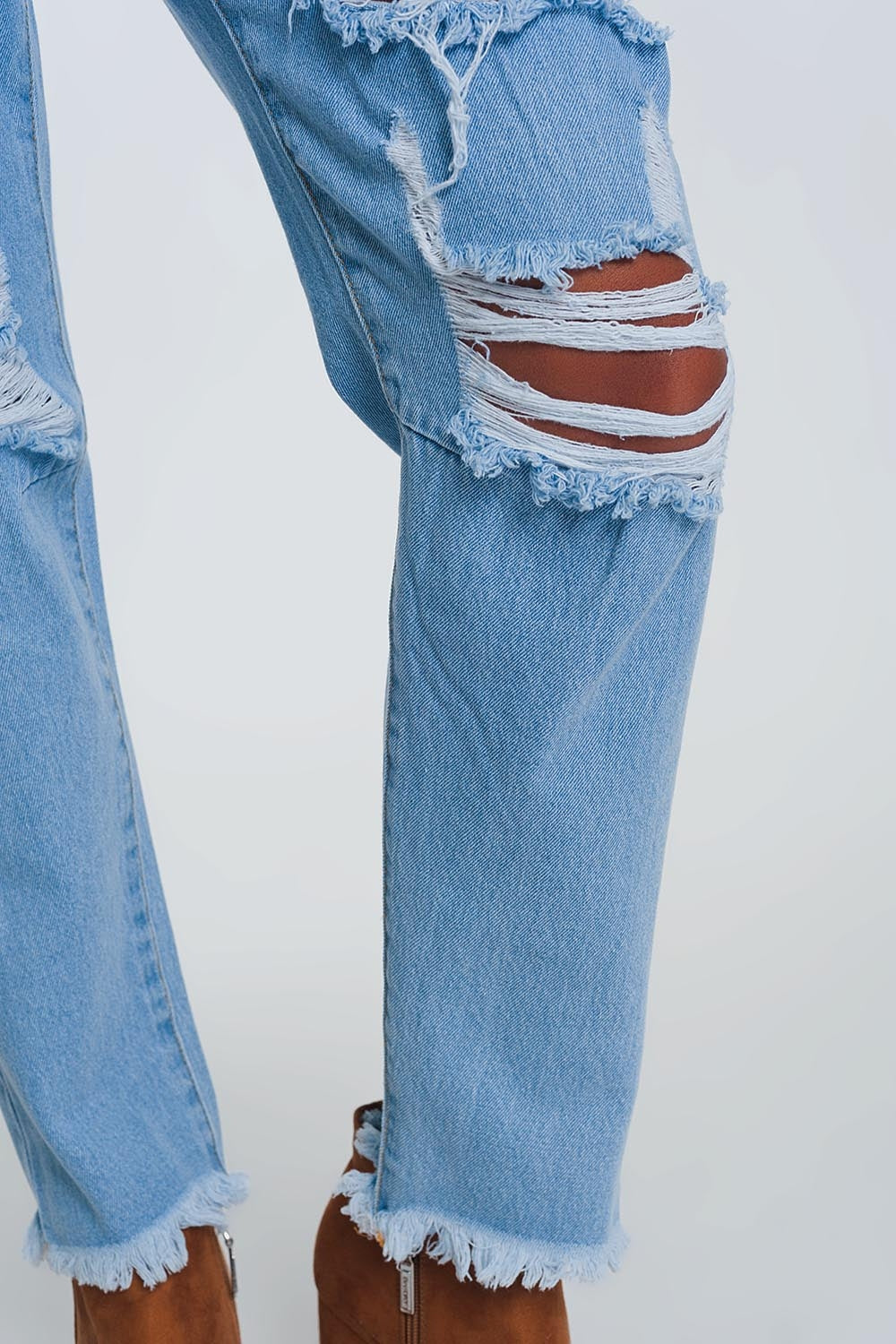 High waist mom jeans with busted knees in light denim