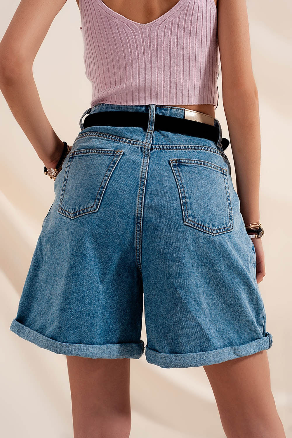 High waisted pleated denim shorts in mid wash