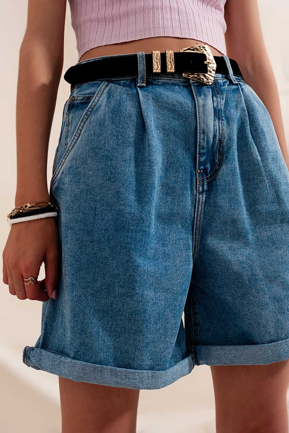 High waisted pleated denim shorts in mid wash