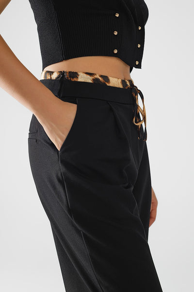 Long black pleated pants with leopard detail at the waist