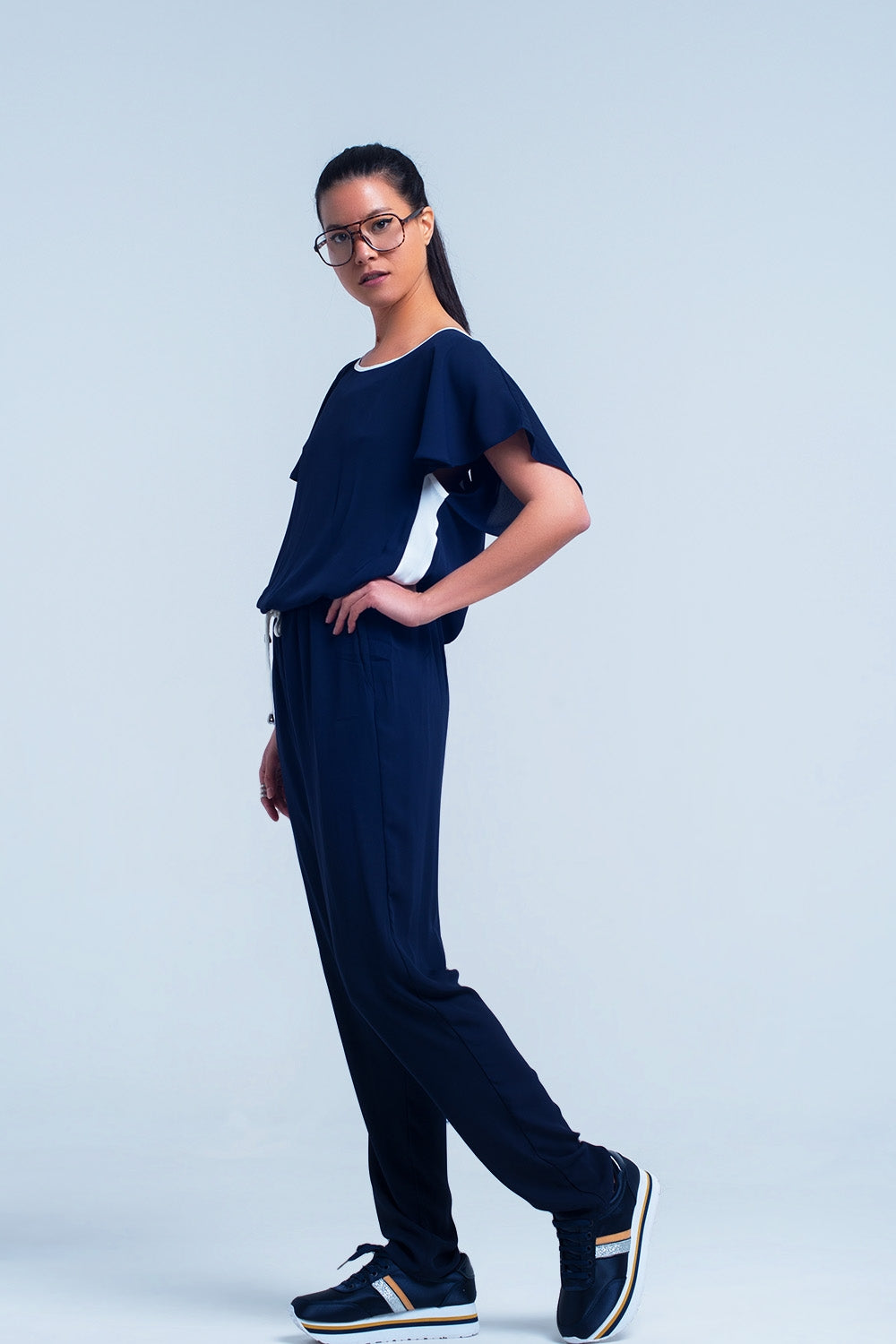 Navy blue jumpsuit with short sleeve and ruffle detail