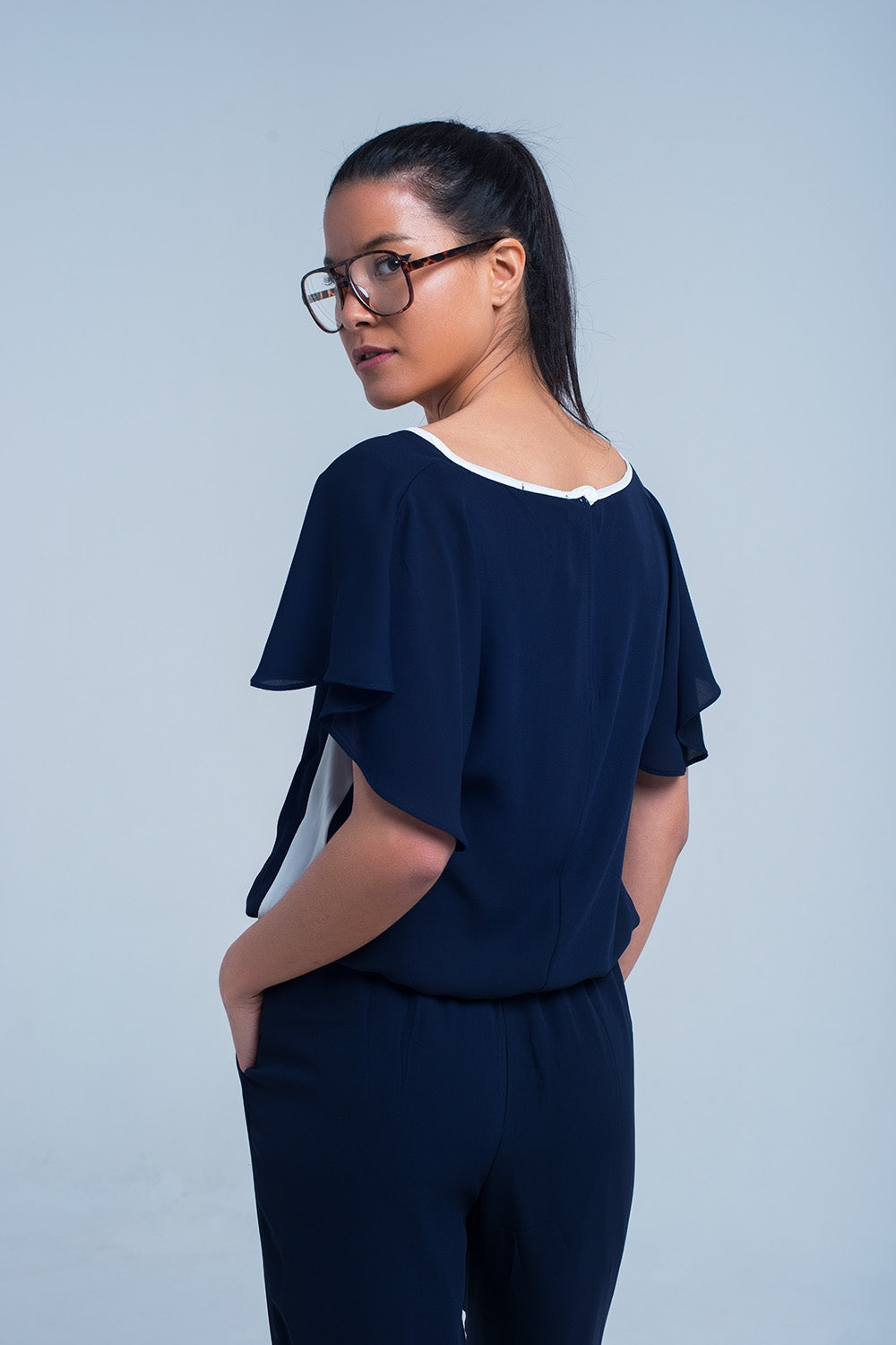 Navy blue jumpsuit with short sleeve and ruffle detail