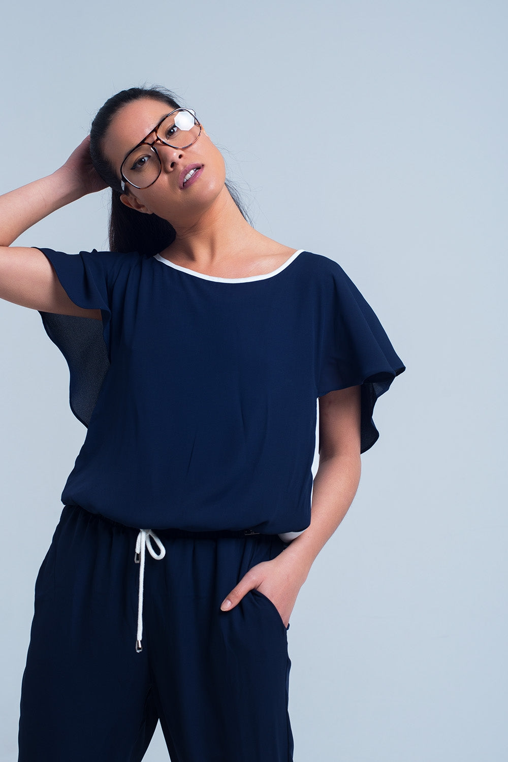 Navy blue jumpsuit with short sleeve and ruffle detail