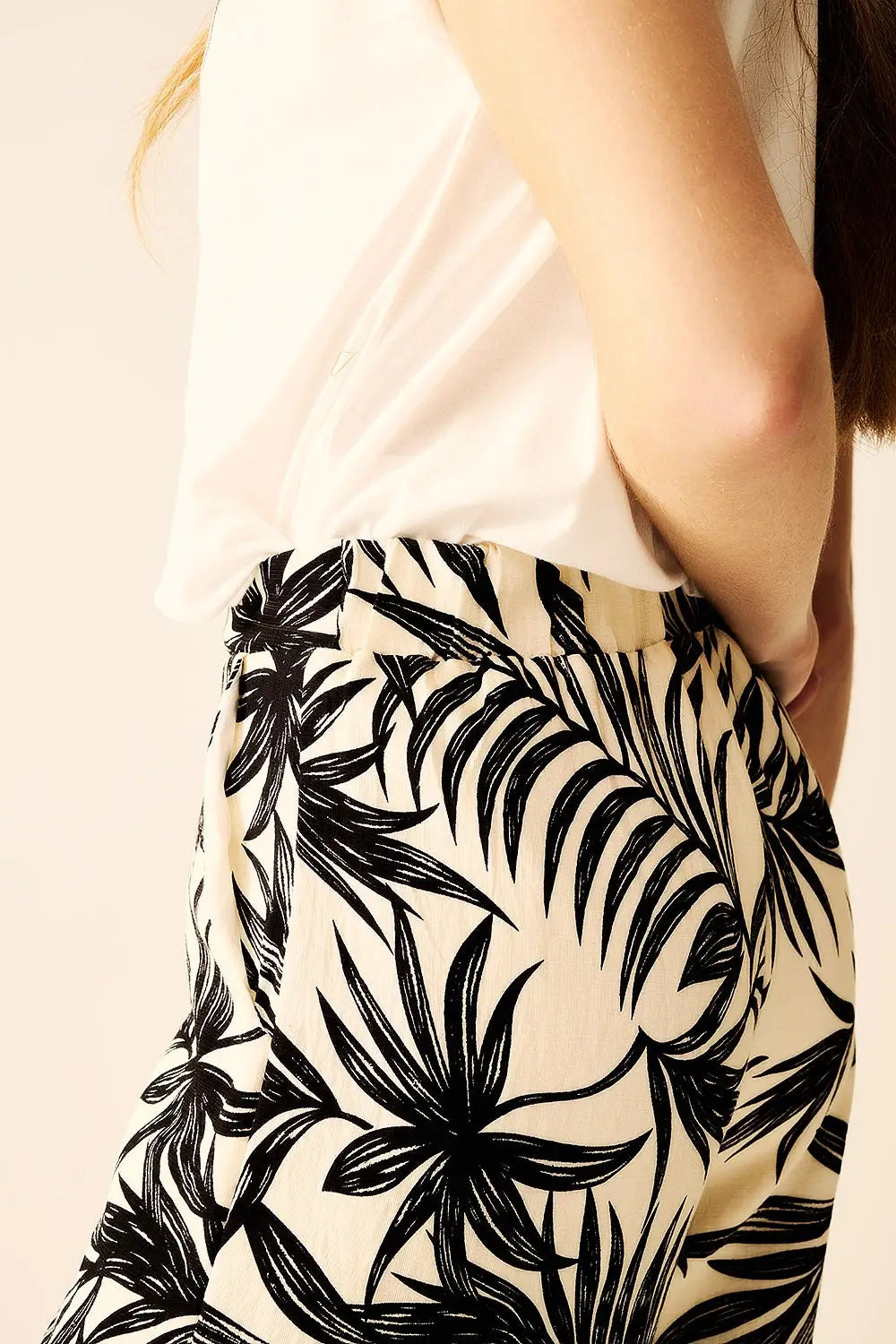 Pantalon à jambes larges en blanc avec détails floraux en noir - Pantalons