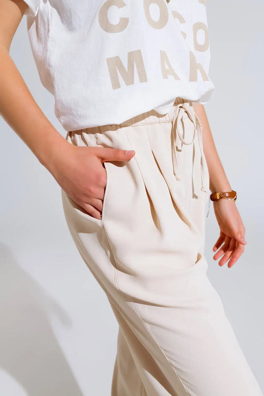 Pantalon en beige avec poches avant et fermeture par cordon de serrage - Pantalons