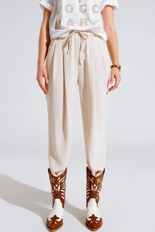 Q2 Pants In beige With Front Pockets And Drawstring Closing