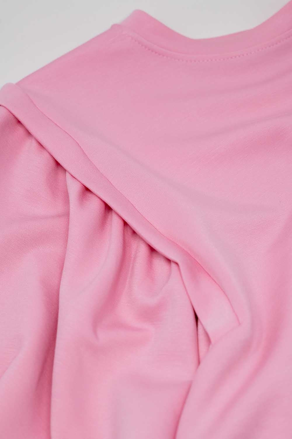 Pink long-sleeved sweater with frontal sewn details on the sides