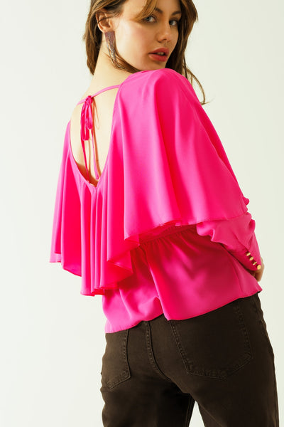 Ruffled V-neck top with buttoned cuffs and tie in the back detal in fuchsia